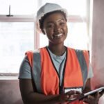 Its not in my toolbox but its just as important shot of a young woman using a digital tablet while working at a construction site _ Premium Photo